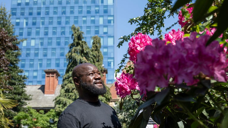 A man admires blossom on a tree